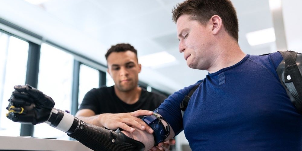 bionic arm being fitted by a healthcare prototype manufacturer 